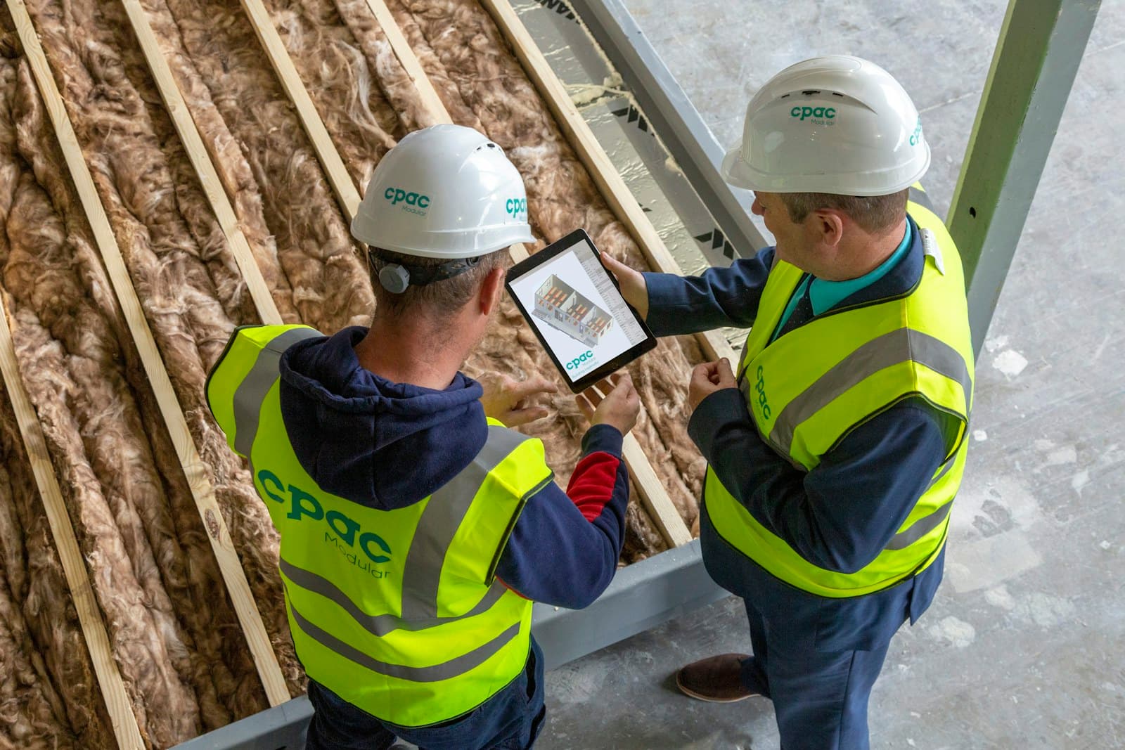 Construction workers reviewing plans for a contractor job-winning guide