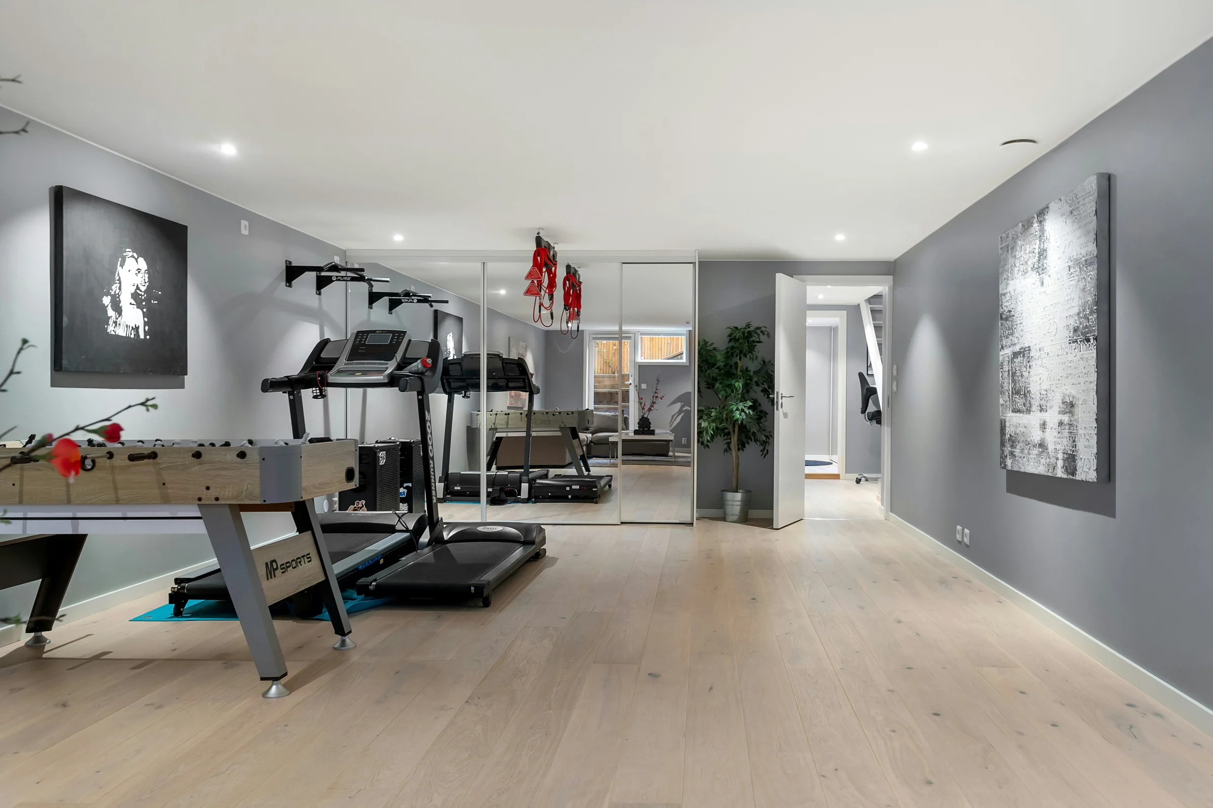 Finished basement with an exercise area and table tennis