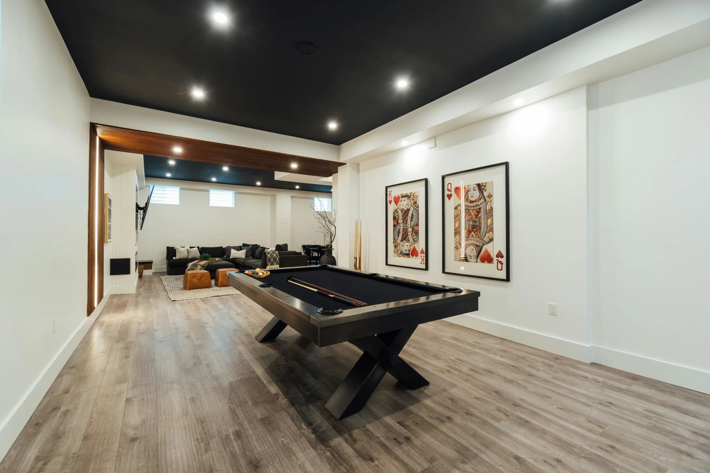 Open basement games room with a timber accent wall