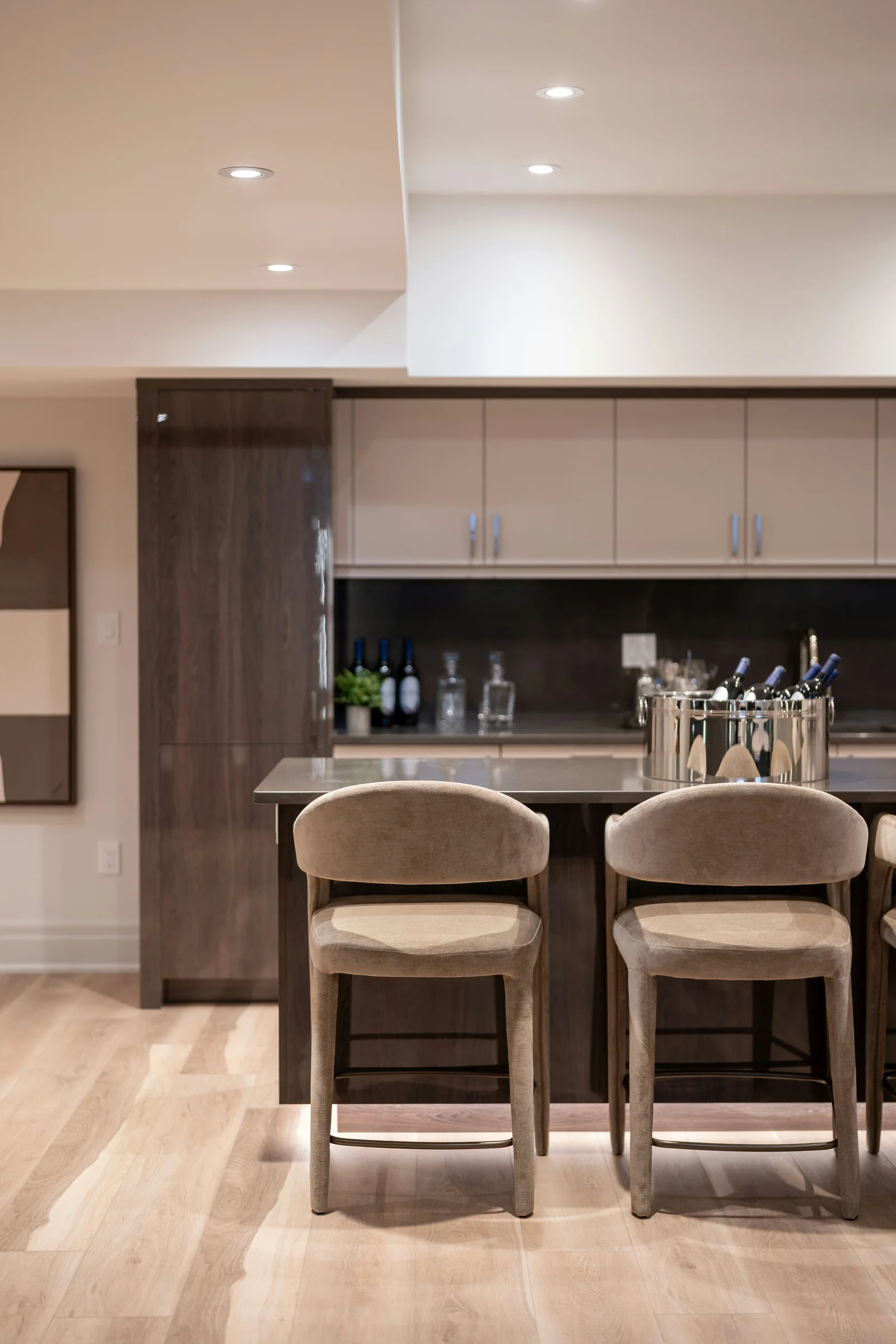 Timber home bar with upholstered stools and recessed lighting