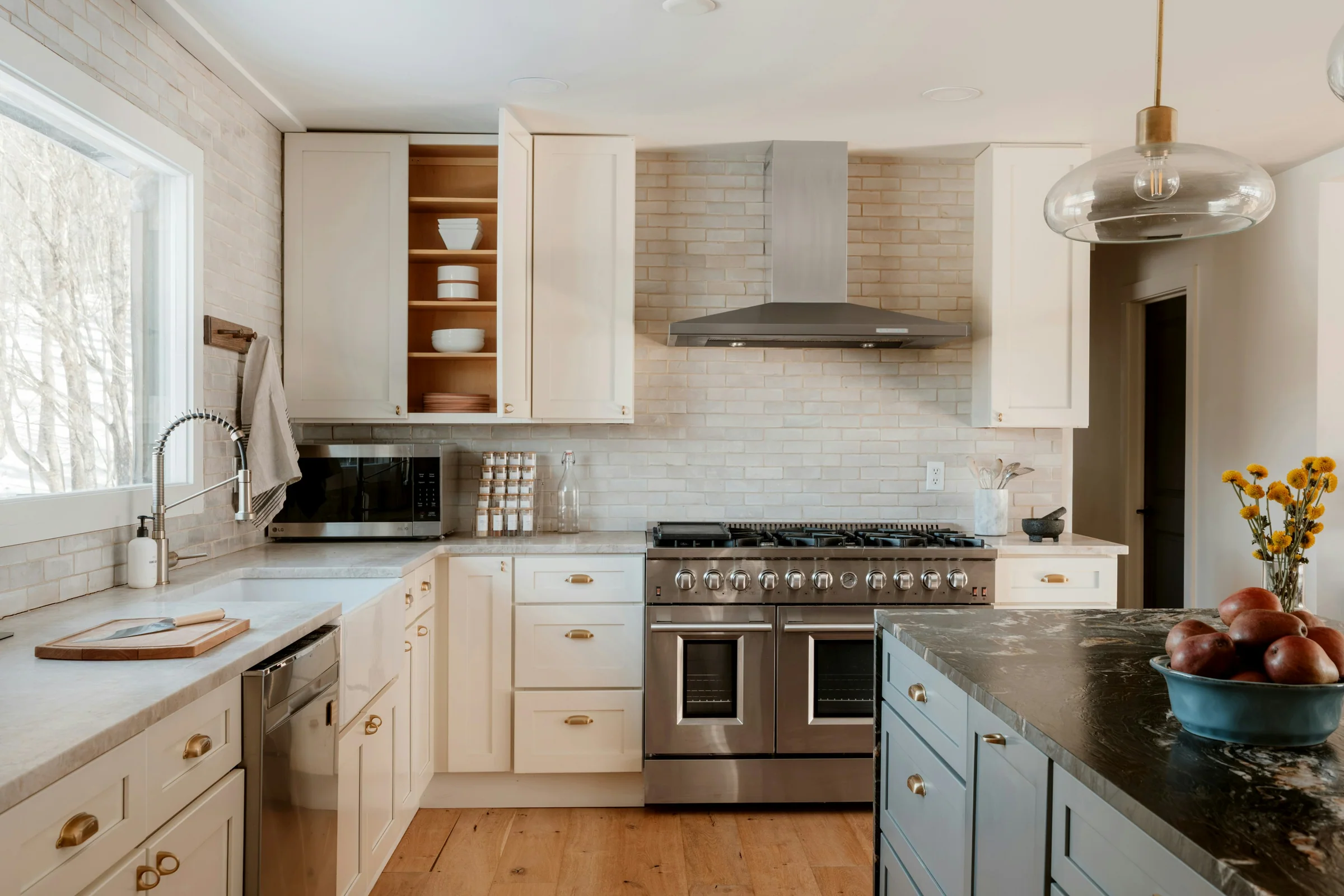 Traditional kitchen with a stainless range and brass hardware