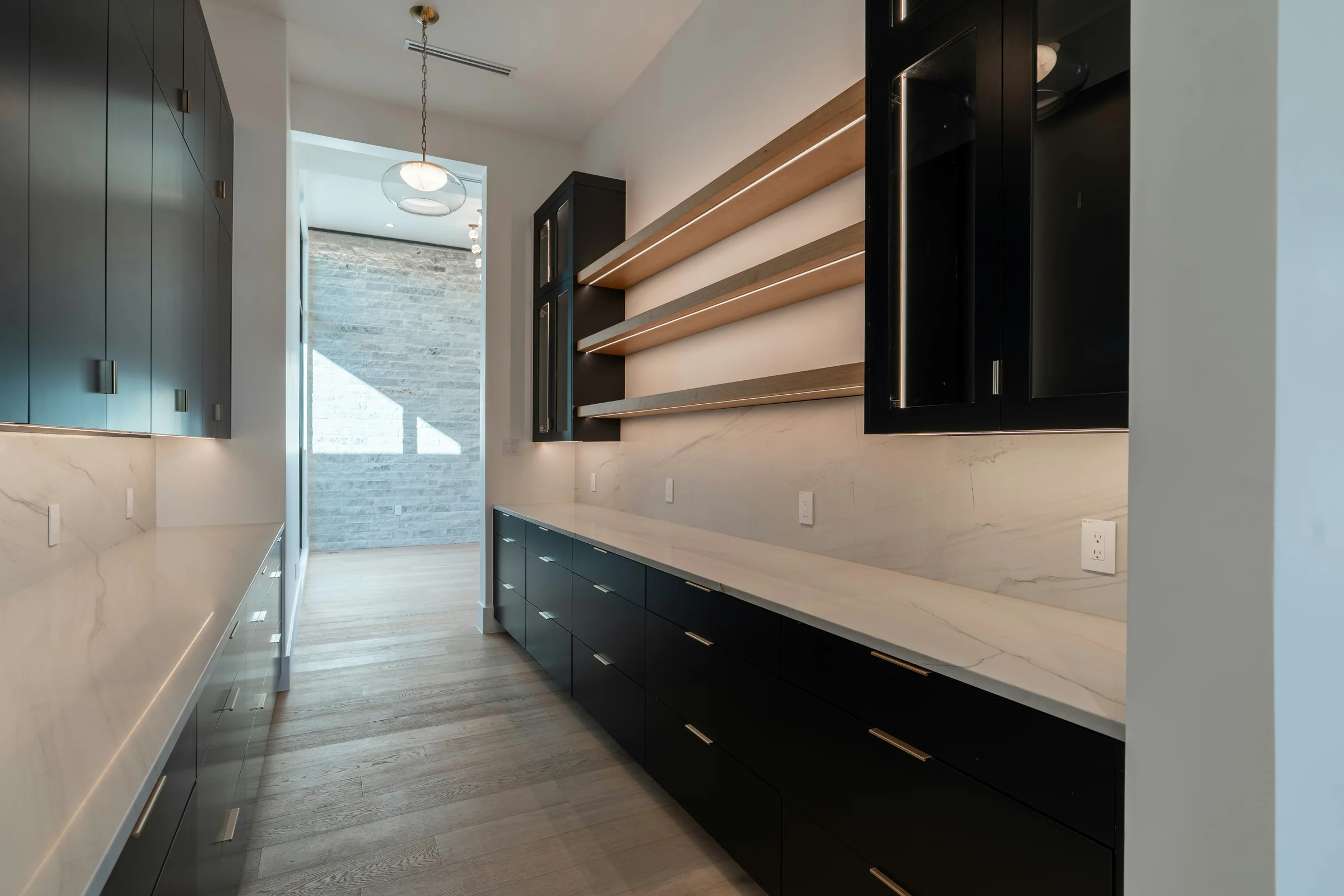 Dark pantry cabinetry with open timber shelving