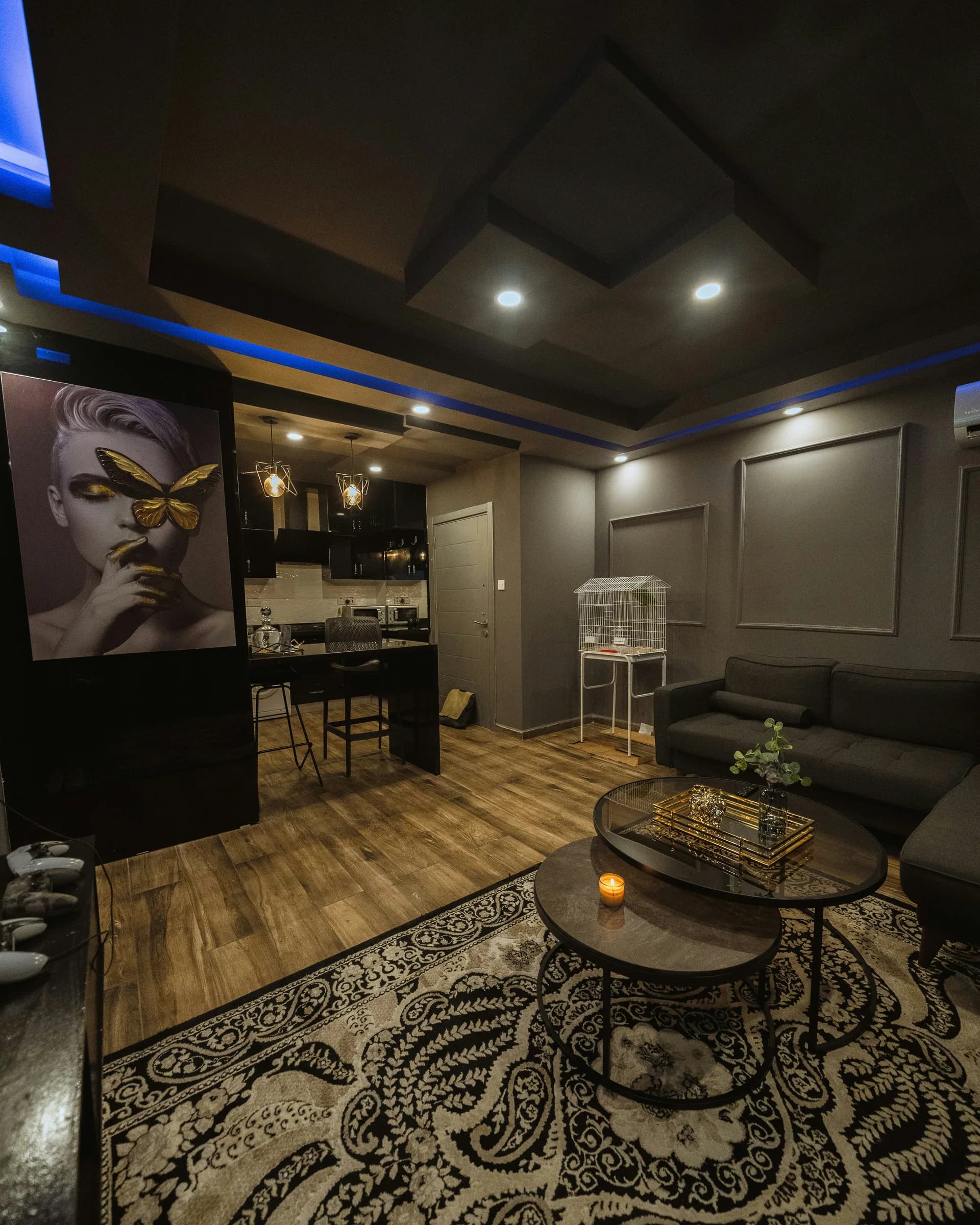 Dark paneled lounge with a patterned rug and low tables