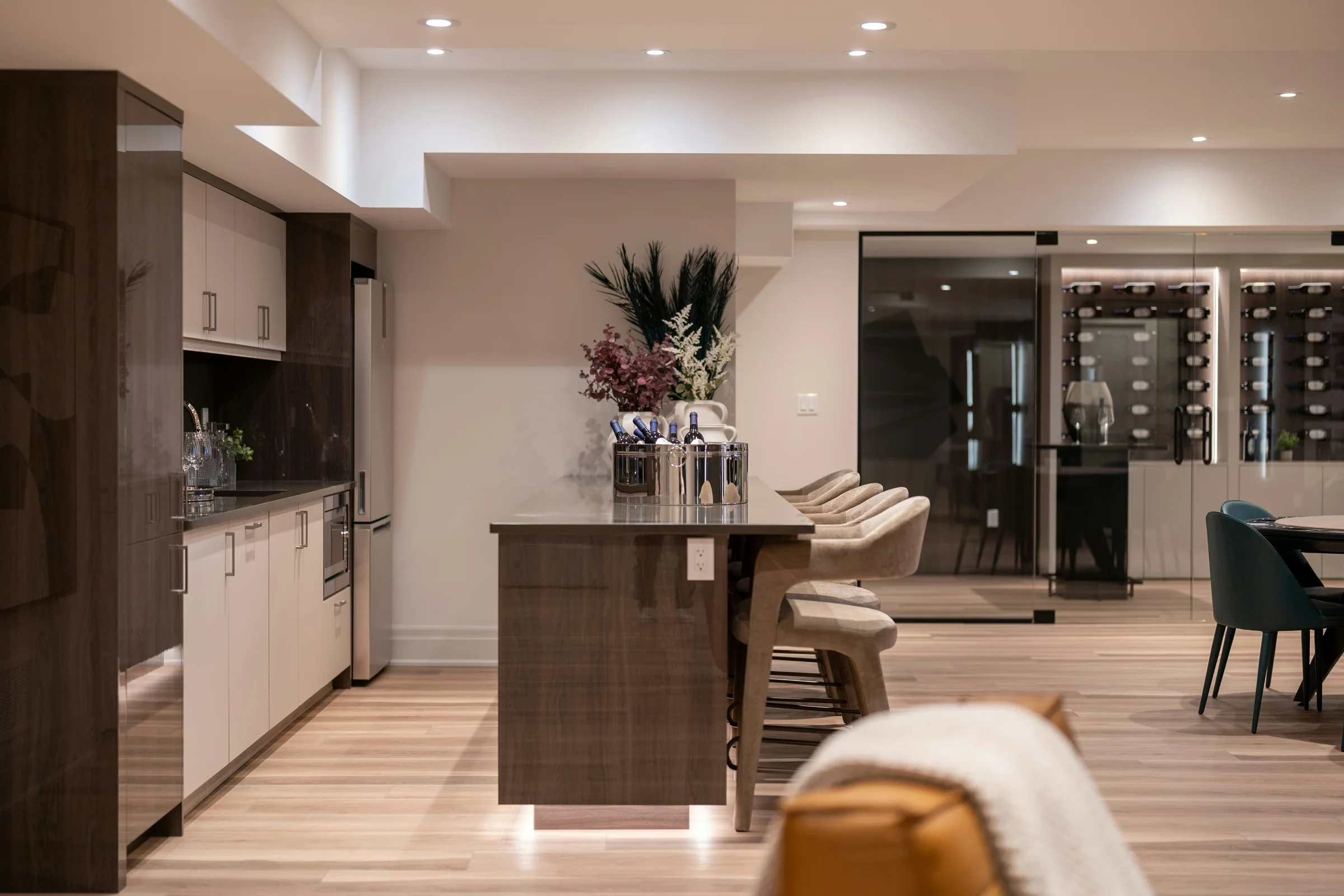 Entertaining kitchen with an island and glass-fronted wine storage