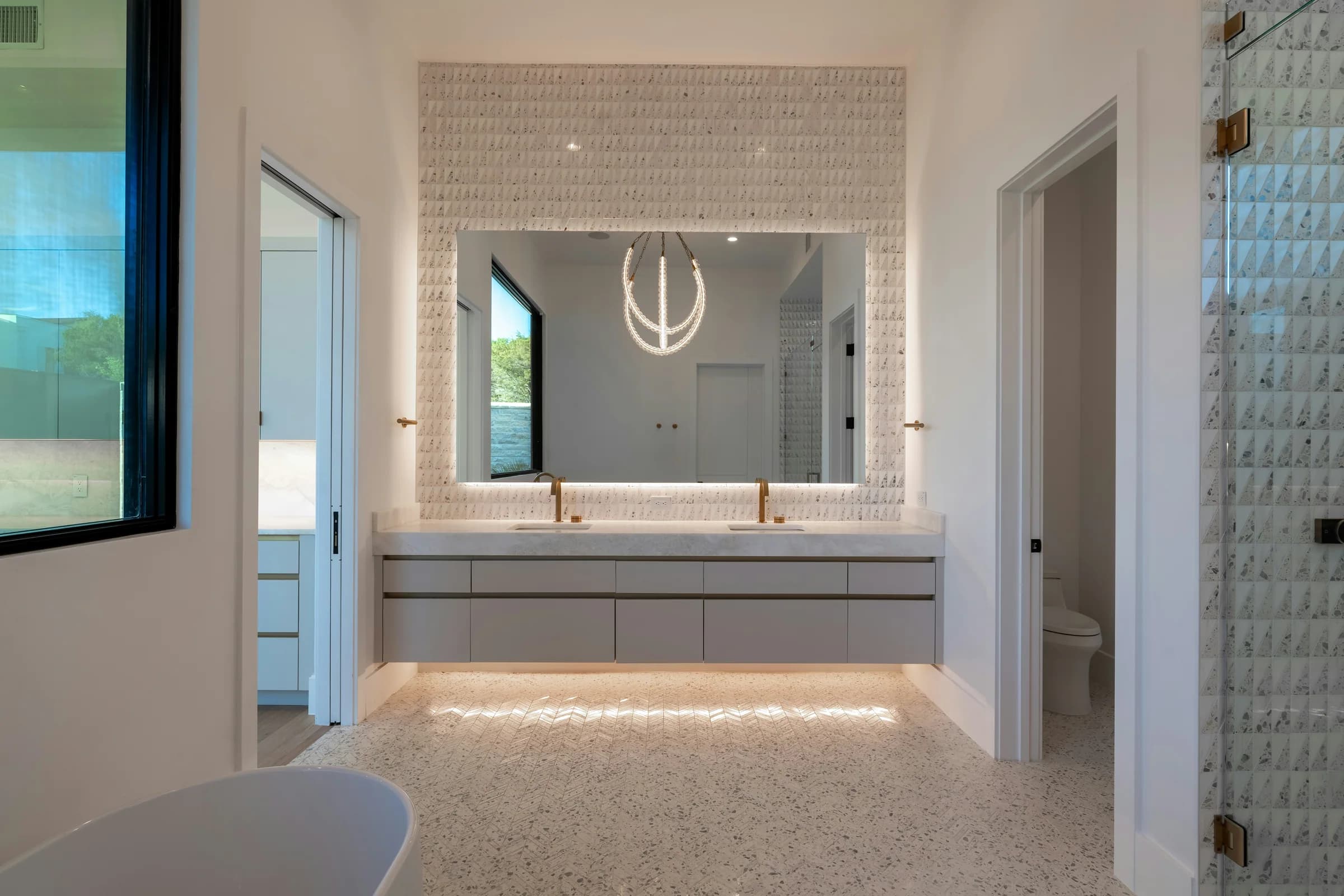 Floating bathroom vanity with softly illuminated mirrors