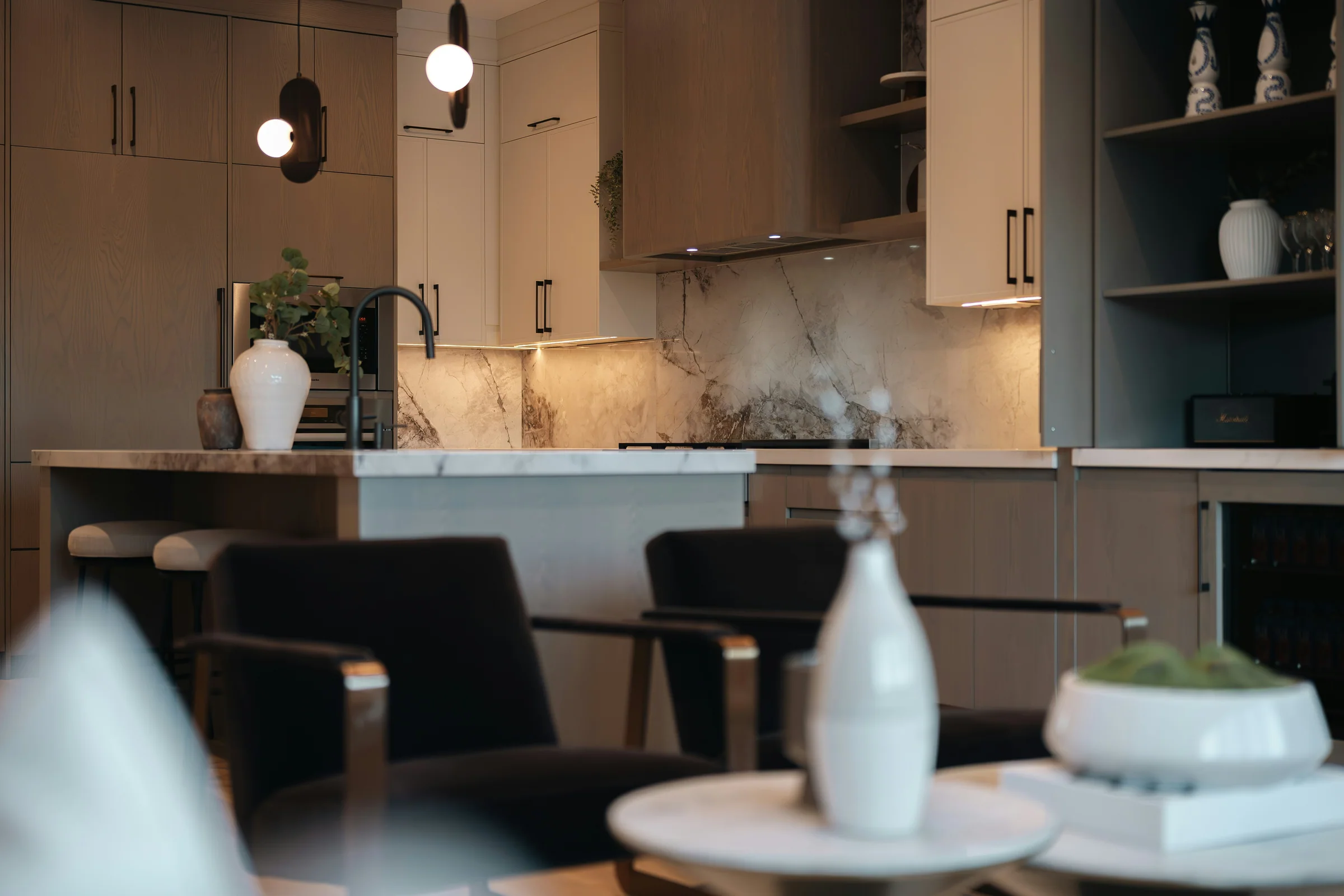 Dining table details in front of a warm timber kitchen