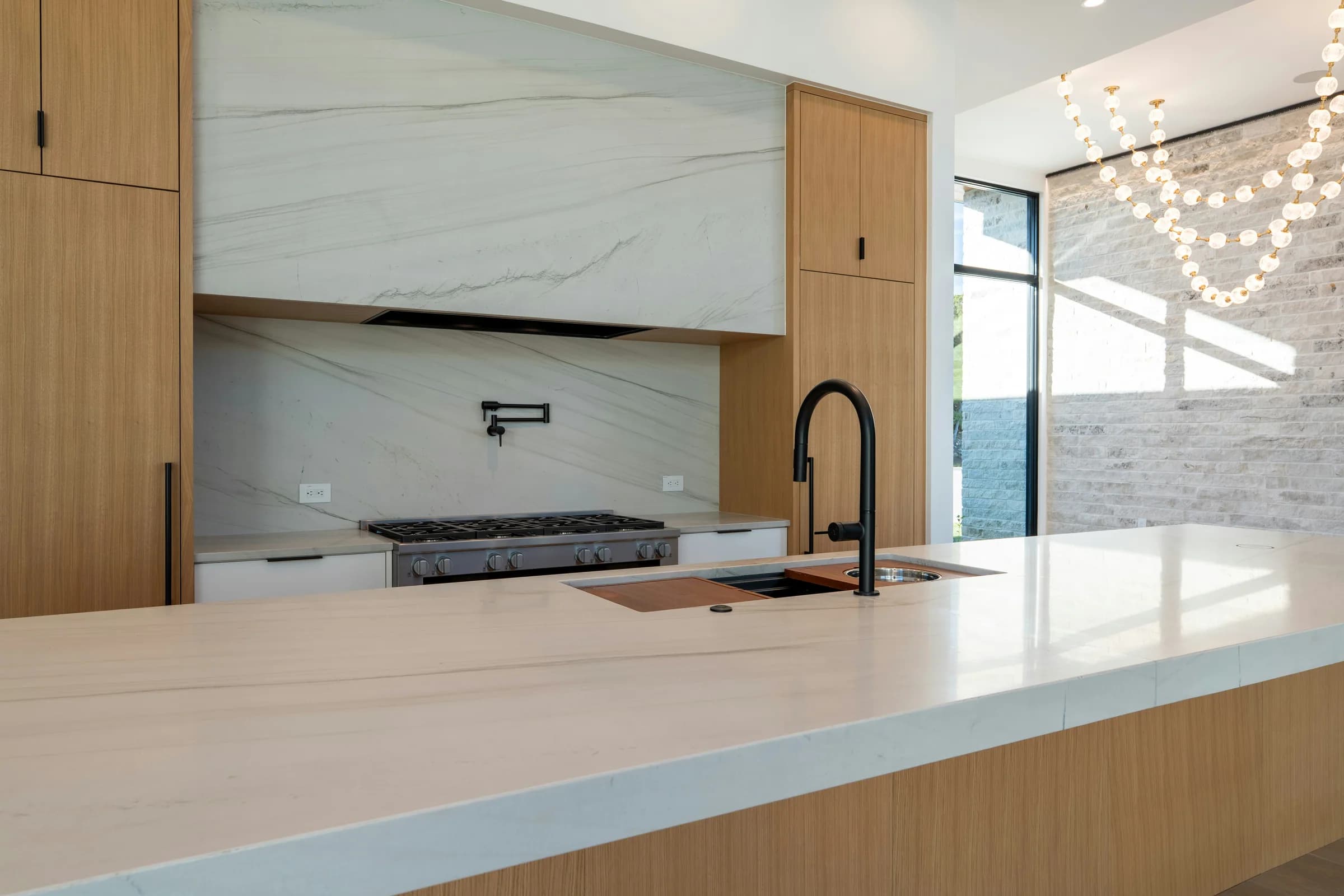 Contemporary oak kitchen with a broad pale stone island