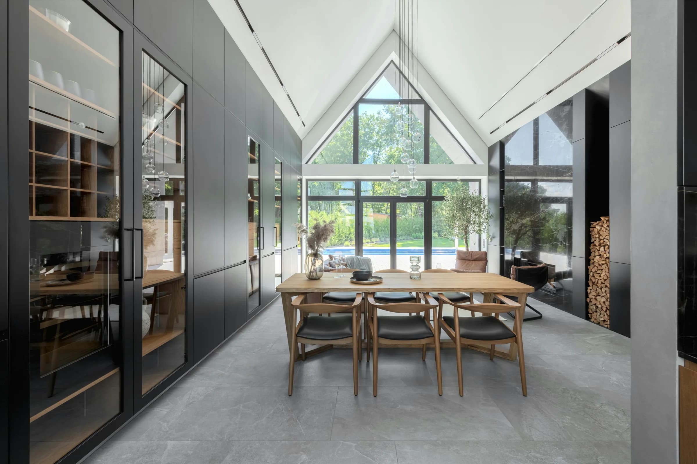 Vaulted dining room with full-height glazing and a timber table
